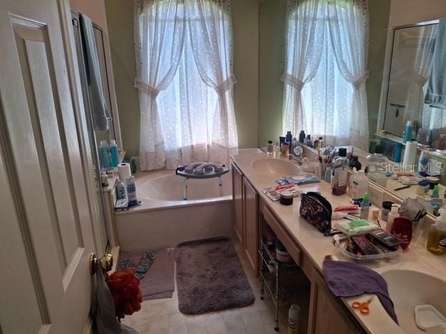 450 Morning Blossom Ln, Oviedo, FL 32765 - full bath featuring a bath, a sink, a shower stall, and double vanity