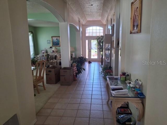 450 Morning Blossom Ln, Oviedo, FL 32765 - hallway with arched walkways, plenty of natural light, and light tile patterned floors