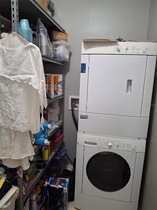 450 Morning Blossom Ln, Oviedo, FL 32765 - clothes washing area featuring stacked washer / drying machine and laundry area