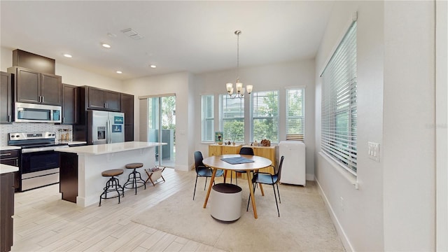 13241 Cormack Ln, Orlando, FL 32827 - dining space with an inviting chandelier, recessed lighting, baseboards, and light wood-type flooring