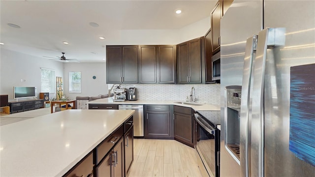 13241 Cormack Ln, Orlando, FL 32827 - kitchen featuring light countertops, decorative backsplash, a sink, a ceiling fan, and appliances with stainless steel finishes