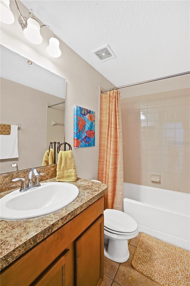 full bathroom featuring tile patterned floors, toilet, a textured ceiling, shower / tub combo, and visible vents