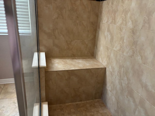 bathroom with a tile shower
