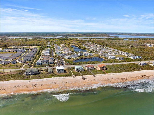 bird's eye view with a water view and a beach view