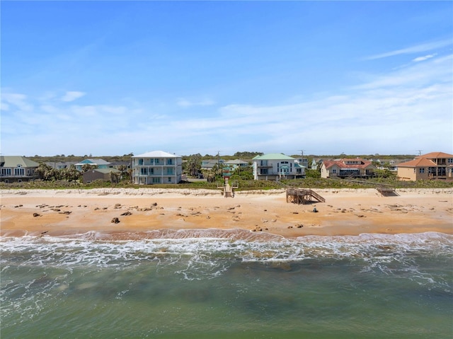 exterior space featuring a beach view and a water view