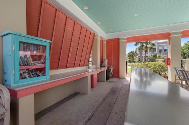 misc room featuring a sink and decorative columns