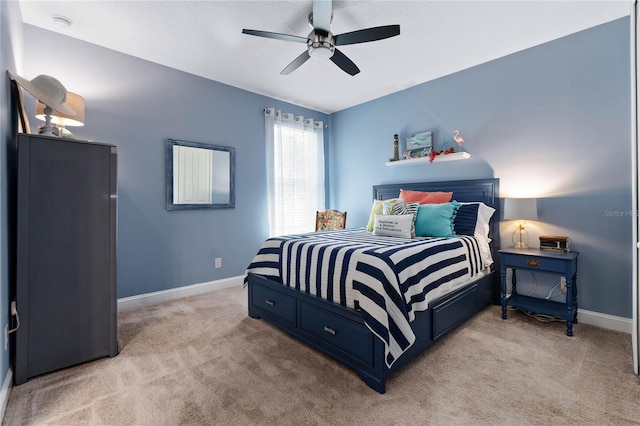 bedroom with baseboards, ceiling fan, and light carpet