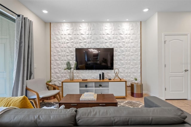 living room with tile patterned floors, baseboards, recessed lighting, and an accent wall