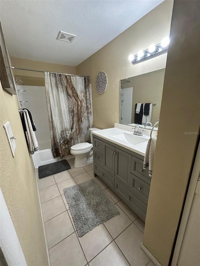 full bath with vanity, shower / tub combo with curtain, tile patterned floors, a textured ceiling, and visible vents