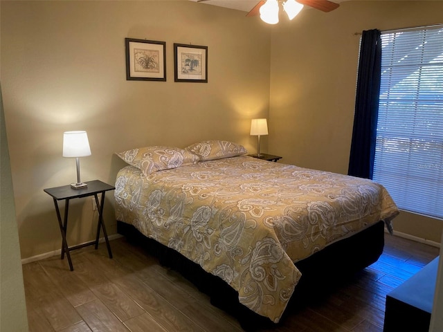 bedroom with wood-type flooring, baseboards, and a ceiling fan
