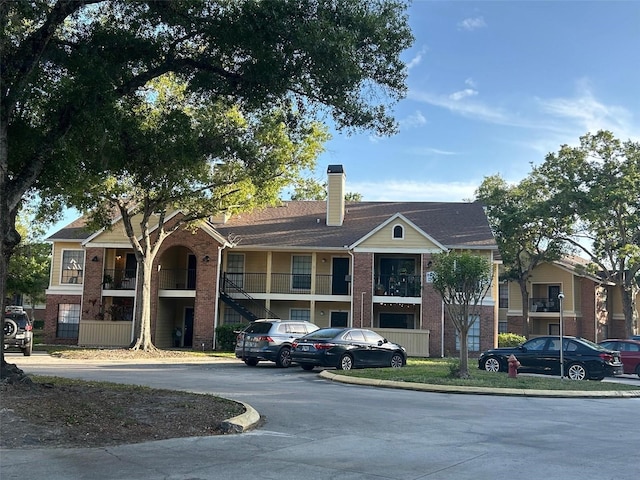 view of building exterior featuring uncovered parking