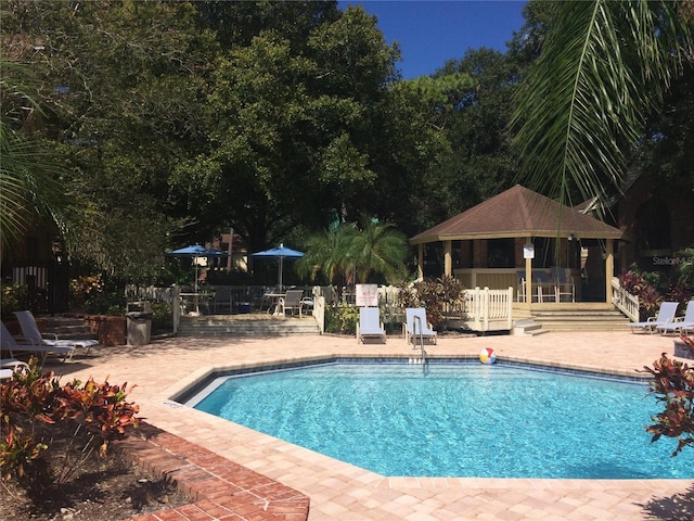 community pool featuring a patio, a gazebo, and fence