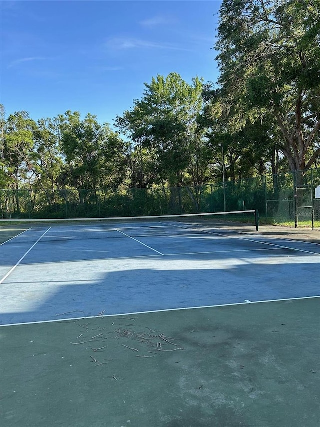 view of sport court featuring fence