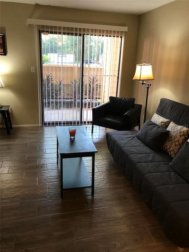 living area with baseboards and wood finish floors