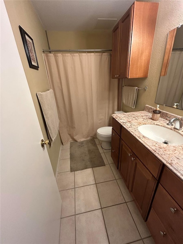 full bath featuring toilet, vanity, a shower with shower curtain, and tile patterned flooring