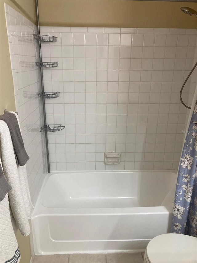bathroom with toilet and shower / bath combination with curtain