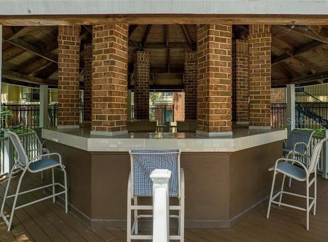 exterior space with wood-type flooring, wood ceiling, and vaulted ceiling with beams