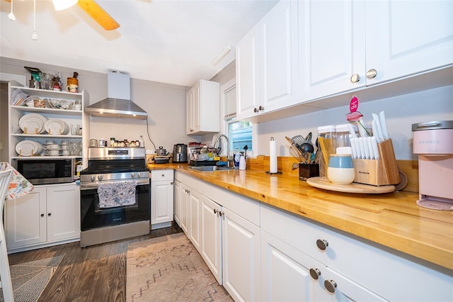 1204 34th St, Orlando, FL 32805 - kitchen featuring butcher block countertops, white cabinets, wall chimney exhaust hood, appliances with stainless steel finishes, and a sink