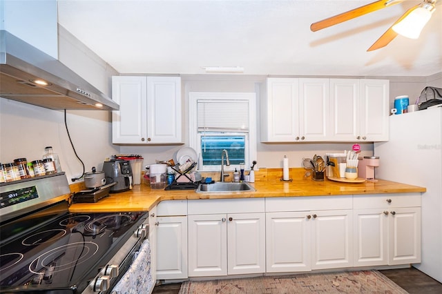 1204 34th St, Orlando, FL 32805 - kitchen featuring a sink, stainless steel range with electric cooktop, wall chimney range hood, and white cabinetry