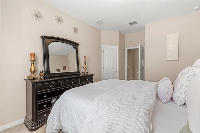 bedroom featuring visible vents, light colored carpet, and baseboards