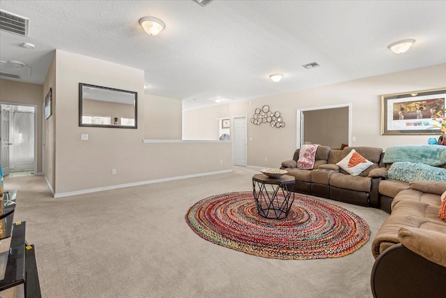 living room with baseboards, visible vents, light colored carpet, and a textured ceiling