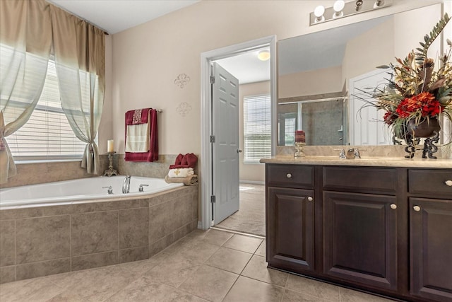 bathroom with tile patterned floors, a bath, a shower stall, and vanity