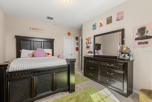 bedroom with light carpet, visible vents, and baseboards