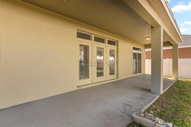 view of patio featuring french doors and fence