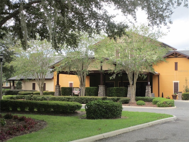 view of front of home with a front yard and stucco siding
