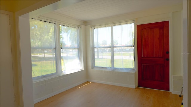 unfurnished sunroom featuring wood finished floors