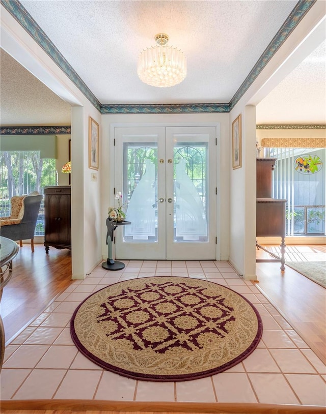 8 Trilby Br, Longwood, FL 32779 - foyer entrance with a chandelier, a wealth of natural light, light tile patterned flooring, and a textured ceiling