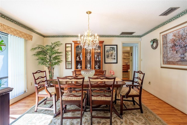 8 Trilby Br, Longwood, FL 32779 - dining space featuring a chandelier, light wood finished floors, and visible vents
