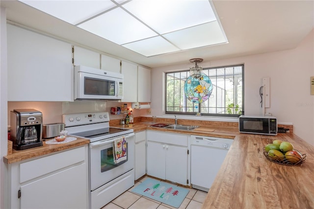 8 Trilby Br, Longwood, FL 32779 - kitchen with white appliances, light tile patterned floors, light countertops, white cabinetry, and a sink