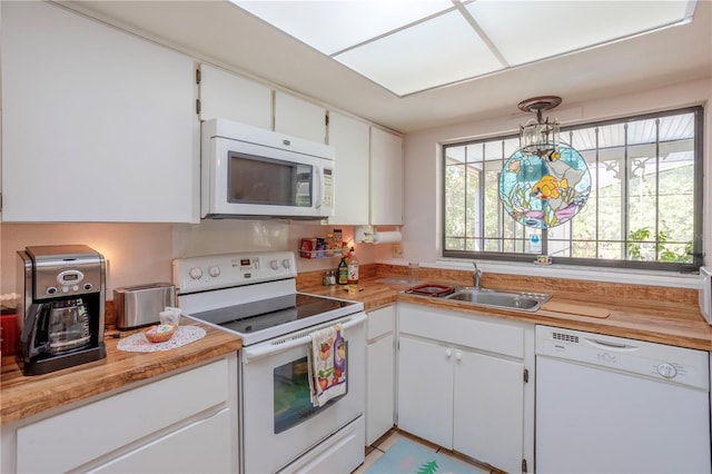 8 Trilby Br, Longwood, FL 32779 - kitchen with a sink, light countertops, white appliances, and white cabinets