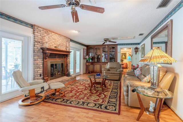 8 Trilby Br, Longwood, FL 32779 - living area featuring a textured ceiling, wood finished floors, ceiling fan, and visible vents