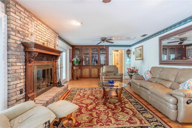 8 Trilby Br, Longwood, FL 32779 - living room featuring light wood-type flooring, a ceiling fan, visible vents, and a textured ceiling