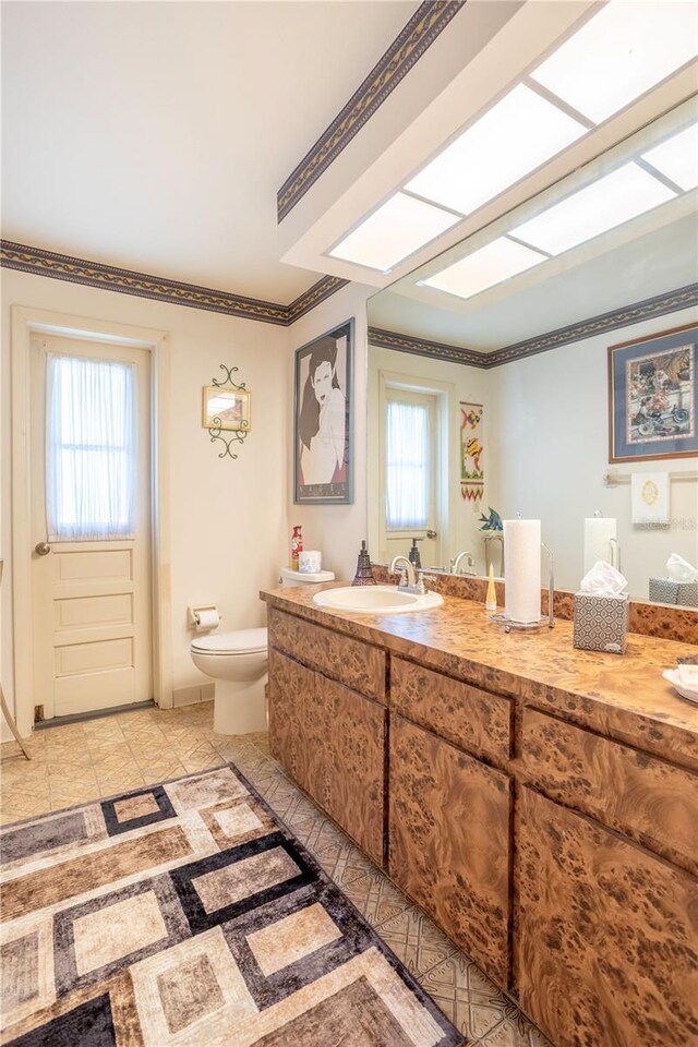 8 Trilby Br, Longwood, FL 32779 - bathroom featuring toilet, vanity, and ornamental molding