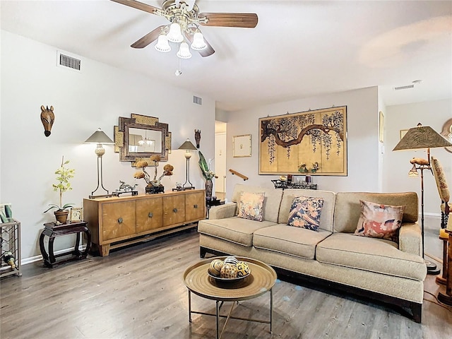 living room with wood finished floors, ceiling fan, and baseboards