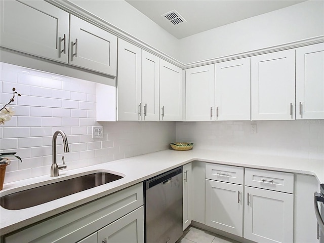 kitchen featuring stainless steel dishwasher, a sink, decorative backsplash, light countertops, and light tile patterned flooring