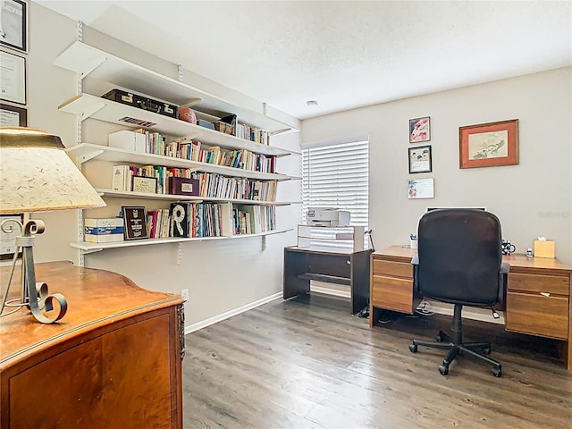 home office with wood finished floors and baseboards