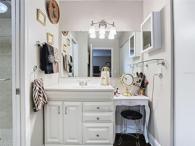 bathroom with vanity and a tile shower