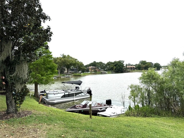 dock with a water view and a lawn
