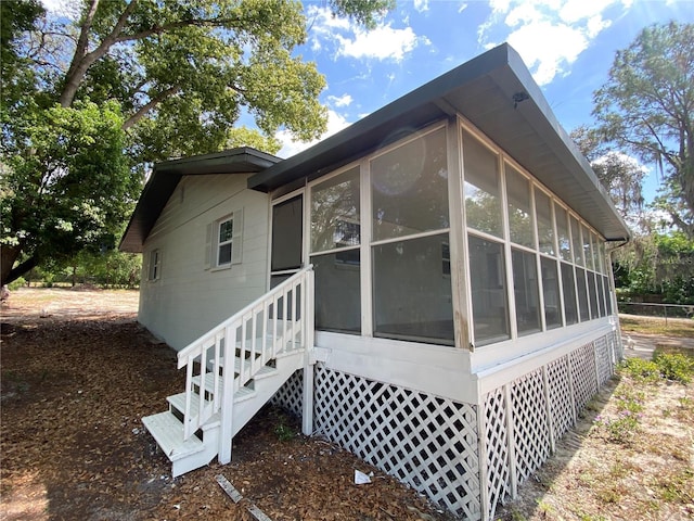 545 Brooks Ct, Polk City, FL 33868 - view of property exterior with a sunroom