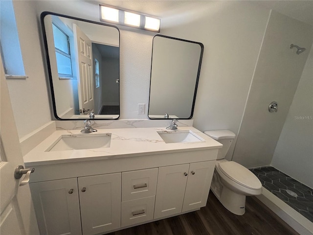 545 Brooks Ct, Polk City, FL 33868 - bathroom featuring wood finished floors, a sink, double vanity, and toilet