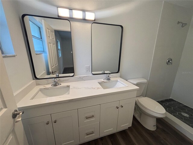 545 Brooks Ct, Polk City, FL 33868 - bathroom featuring toilet, wood finished floors, a sink, and double vanity