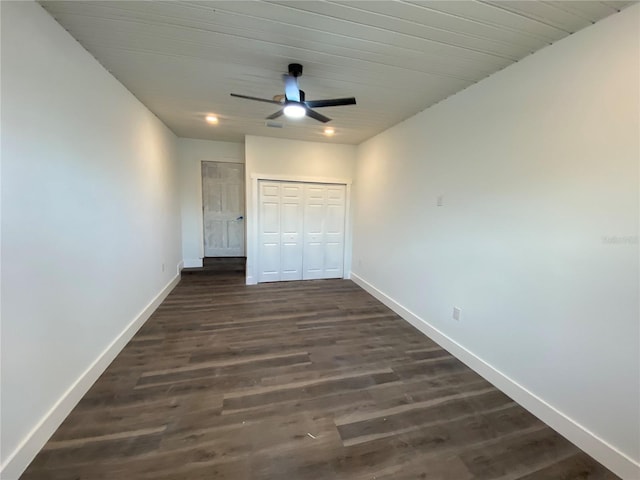 545 Brooks Ct, Polk City, FL 33868 - unfurnished bedroom with a closet, a ceiling fan, baseboards, and dark wood-style floors