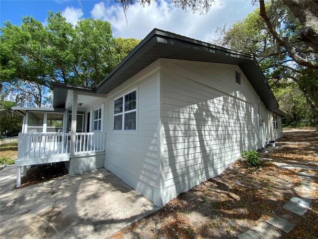 545 Brooks Ct, Polk City, FL 33868 - view of side of home with covered porch