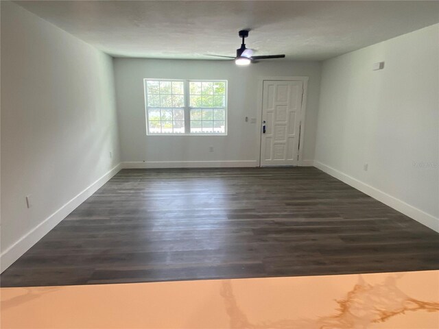 545 Brooks Ct, Polk City, FL 33868 - interior space featuring baseboards, a ceiling fan, and dark wood-style floors