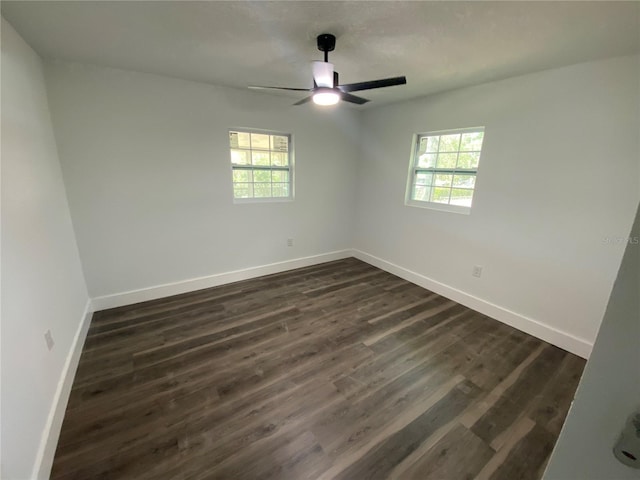 545 Brooks Ct, Polk City, FL 33868 - empty room with dark wood finished floors, baseboards, and plenty of natural light