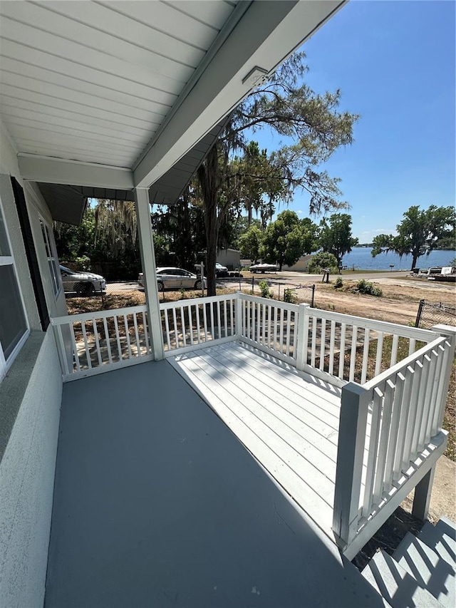 545 Brooks Ct, Polk City, FL 33868 - wooden terrace featuring a water view and covered porch